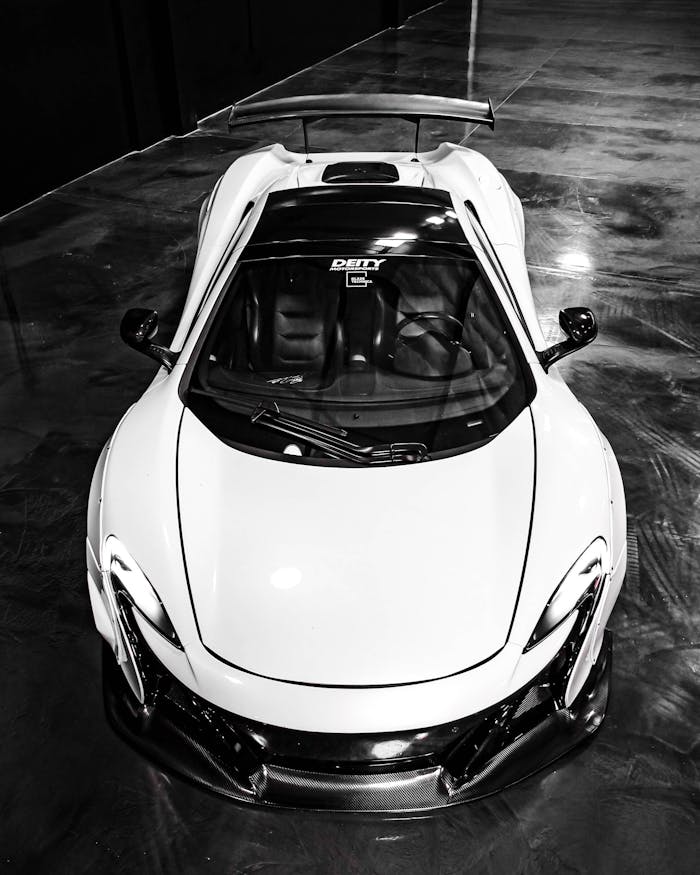 Stylish white sports car photographed from above, showcasing luxury and elegance.